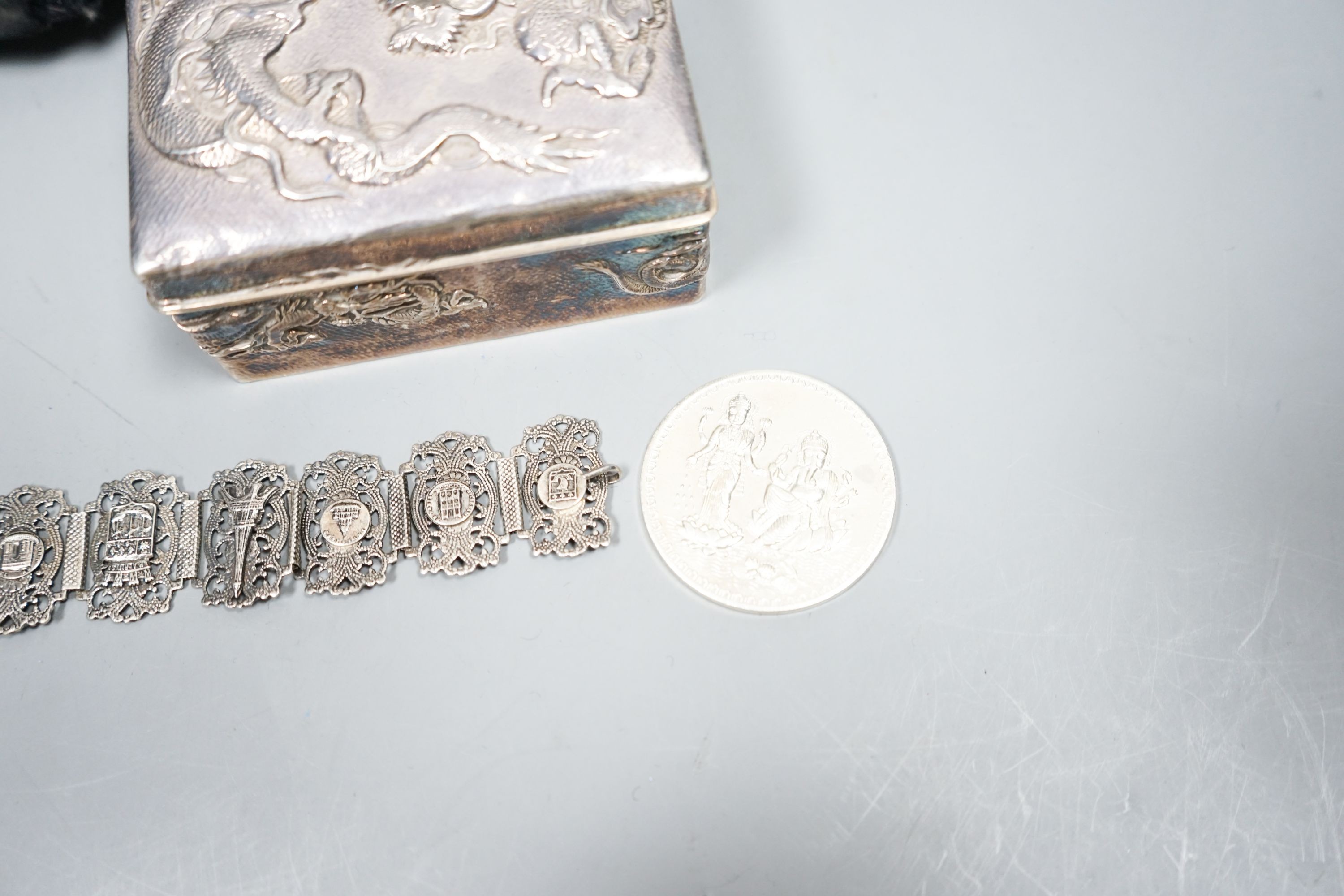 A Japanese silver box, bracelet, medal and military cap